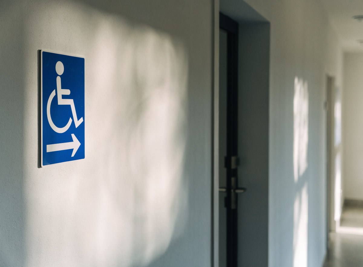 Pictogramme d'accessibilité installé sur un mur d'hôtel à côté d'une porte